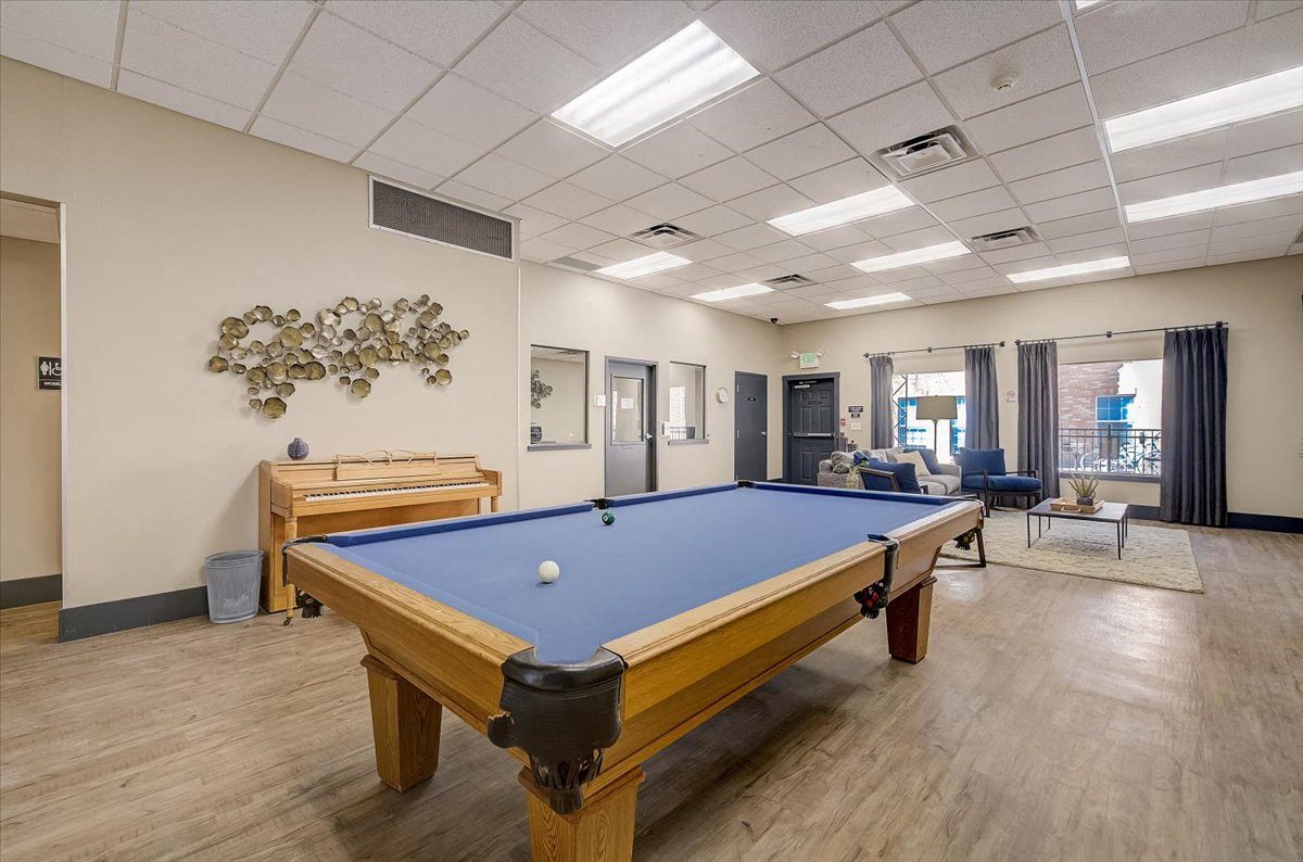 a pool table and foosball table in a resident clubhouse